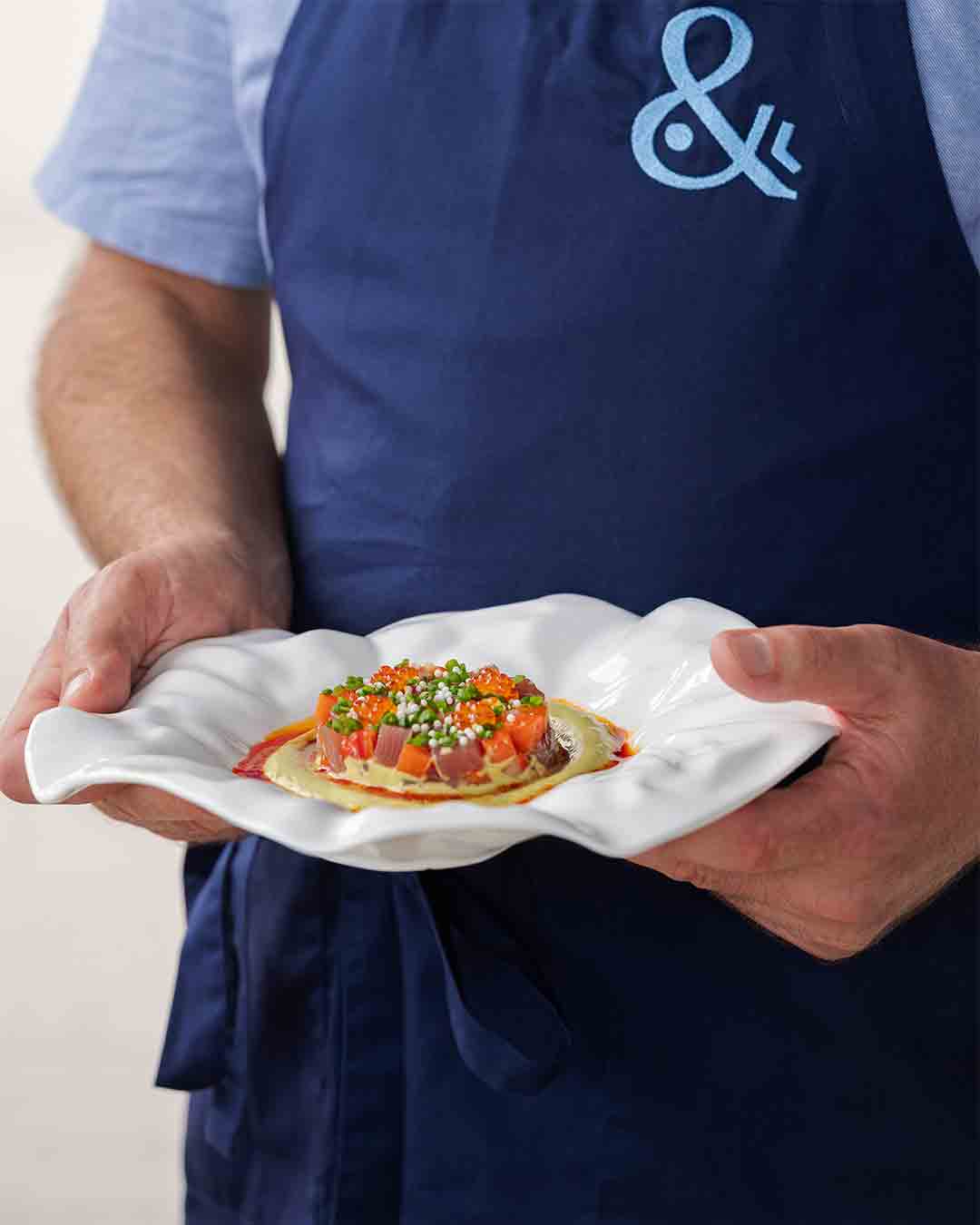 Chef presenting fresh locally sourced fish at Fish& restaurant, Eden Island
